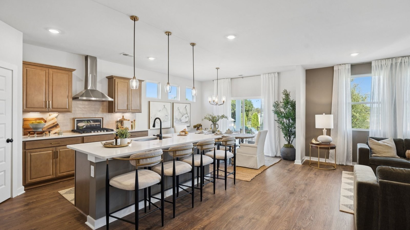 306 Harvest Point Boulevard Spring Hill, TN 37174 - Photo 15 of 70 a kitchen with stainless steel appliances granite countertop a stove a refrigerator a kitchen island a dining table and chairs with wooden floor