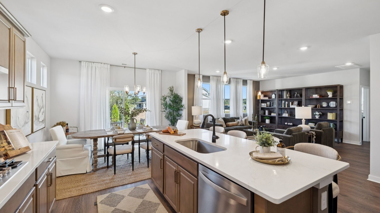 306 Harvest Point Boulevard Spring Hill, TN 37174 - Photo 21 of 70 a open dining room with stainless steel appliances granite countertop a dining table chairs and a living room