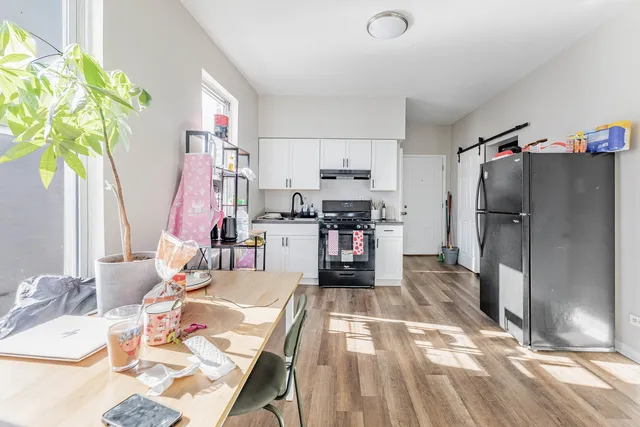 a kitchen with stainless steel appliances kitchen island granite countertop a refrigerator and a stove