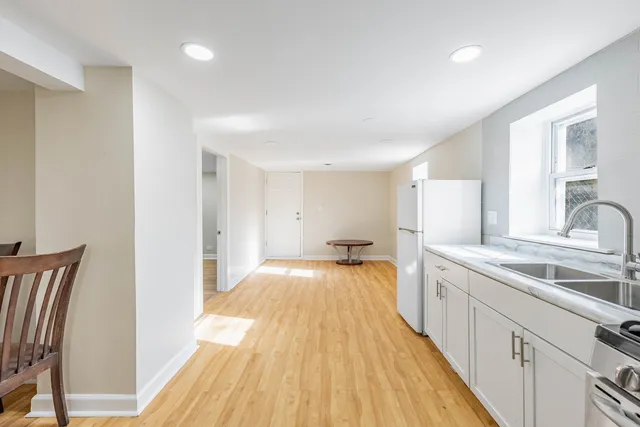 a view of empty room with wooden floor