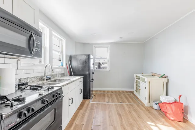 a kitchen with stainless steel appliances granite countertop a refrigerator stove and sink