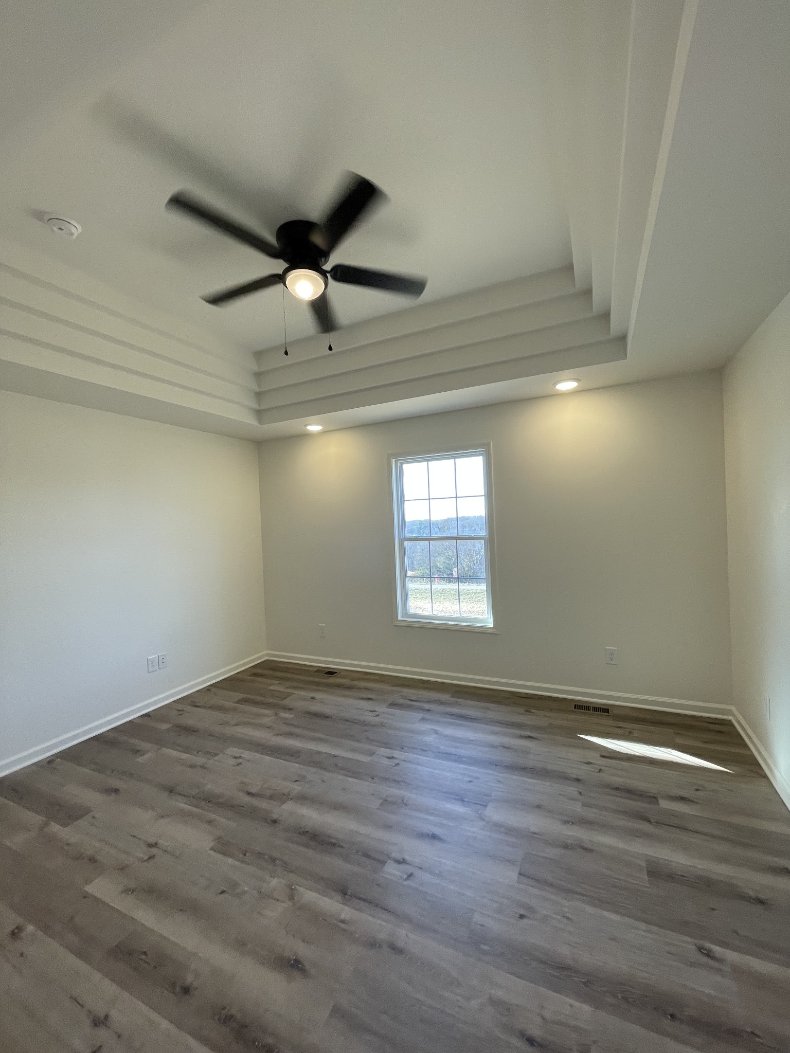 586 Pleasant Hill Road Lafayette, TN 37083 - Photo 21 of 38 an empty room with wooden floor and windows