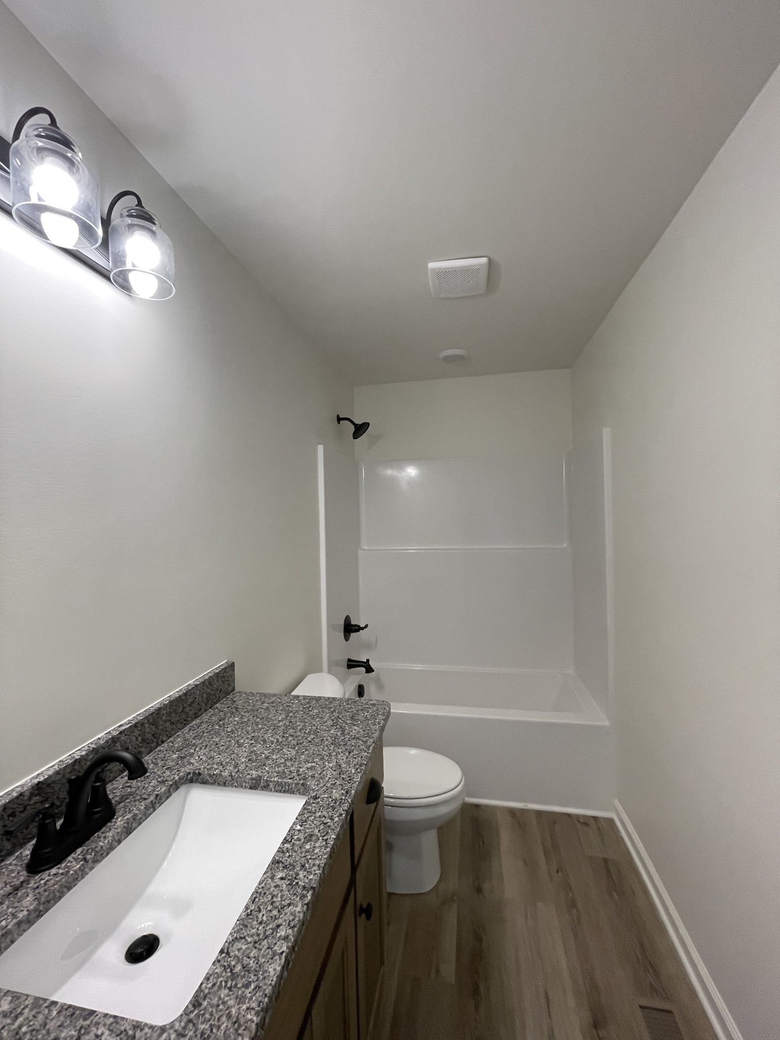586 Pleasant Hill Road Lafayette, TN 37083 - Photo 23 of 38 a bathroom with a granite countertop sink a toilet and shower