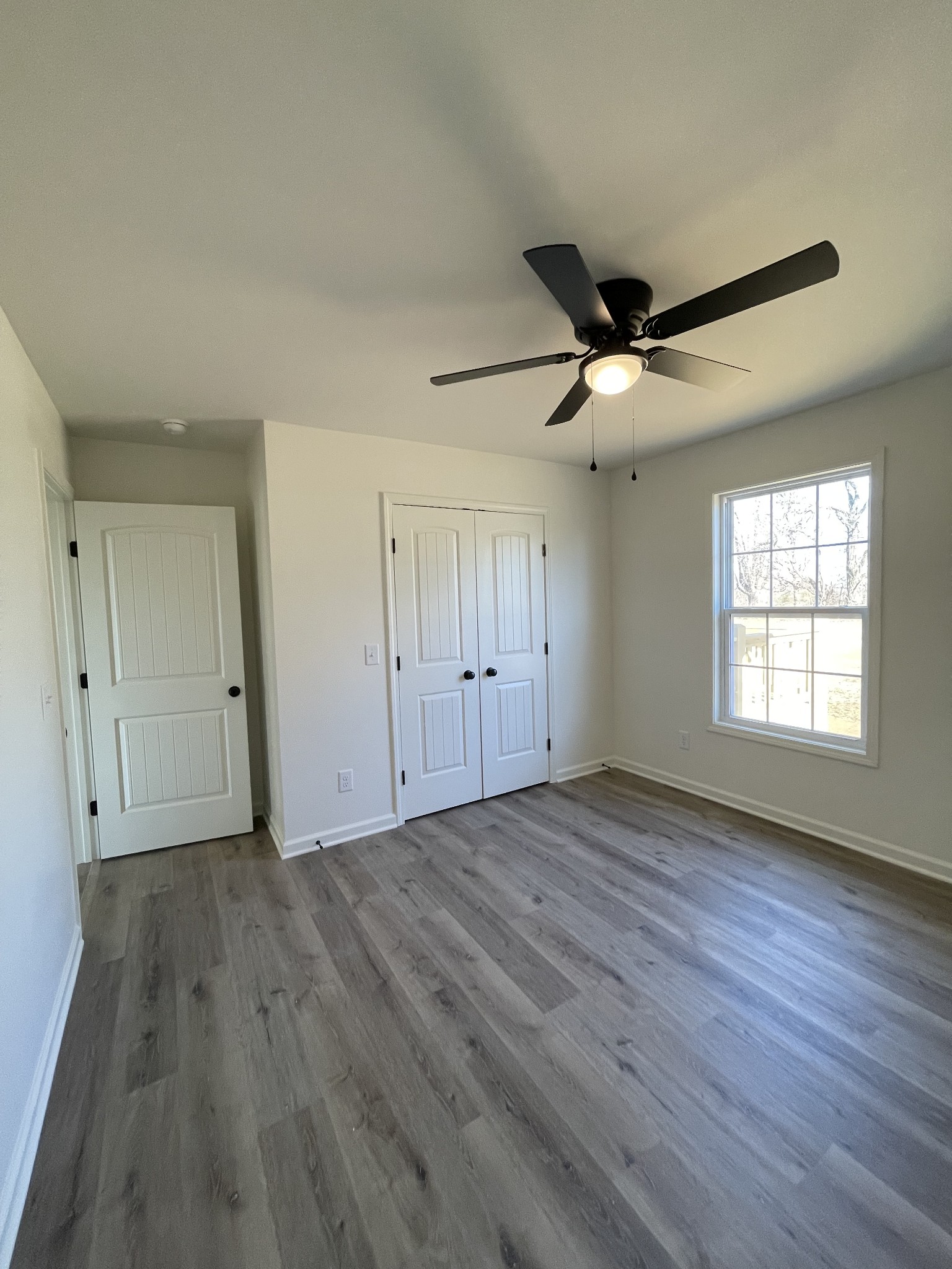 586 Pleasant Hill Road Lafayette, TN 37083 - Photo 27 of 38 wooden floor in an empty room with a window