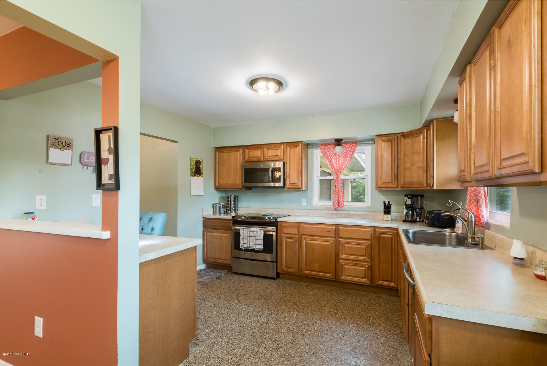 3635 Montgomery Road Mims, FL 32754 - Photo 3 of 19 a kitchen with stainless steel appliances granite countertop a sink and cabinets