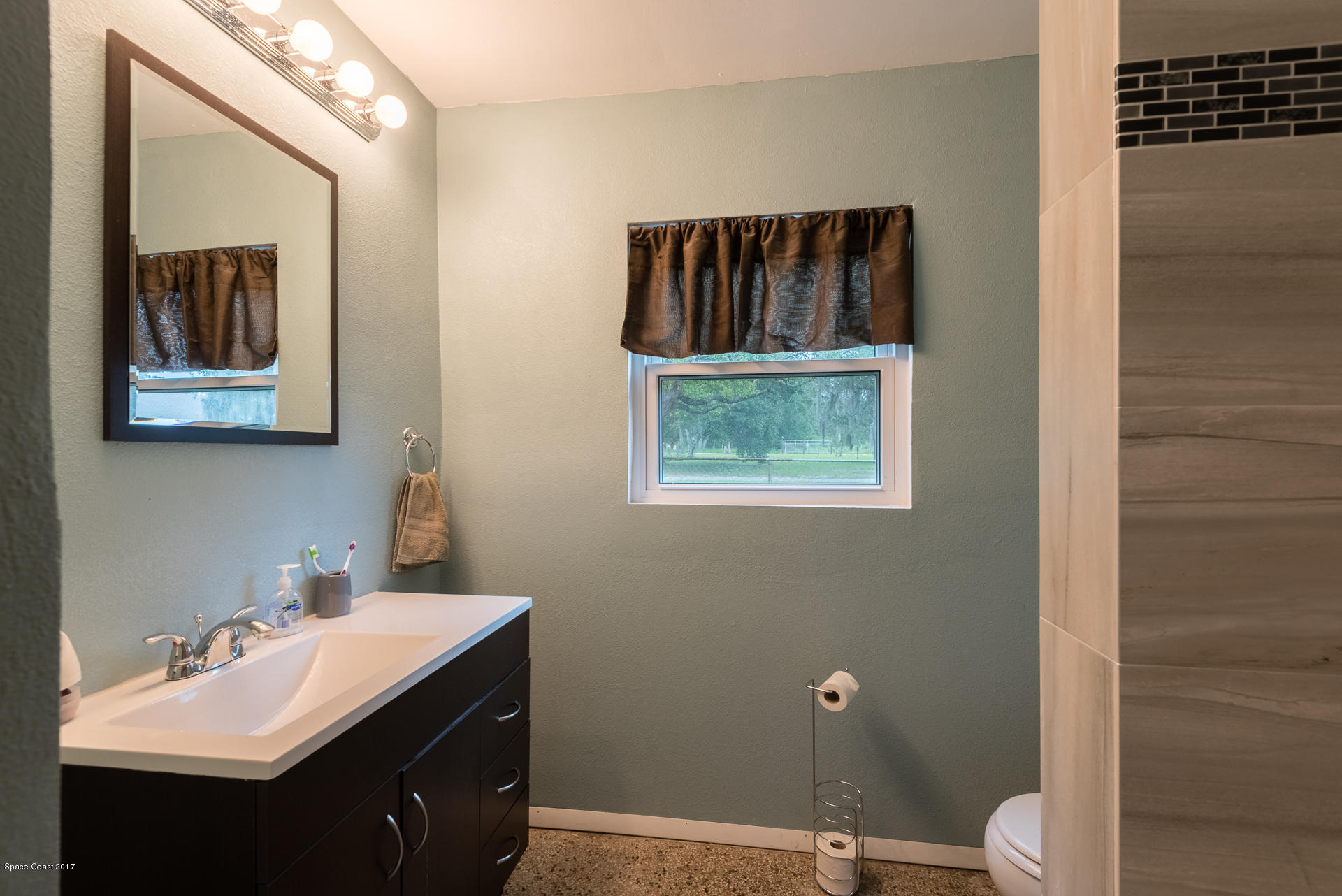 3635 Montgomery Road Mims, FL 32754 - Photo 5 of 19 a bathroom with a sink mirror and toilet