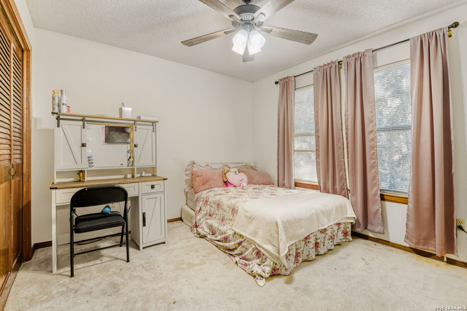 29342 Seabiscuit Drive Fair Oaks Ranch, TX 78015 - Photo 20 of 45 a bedroom with a bed and a chandelier