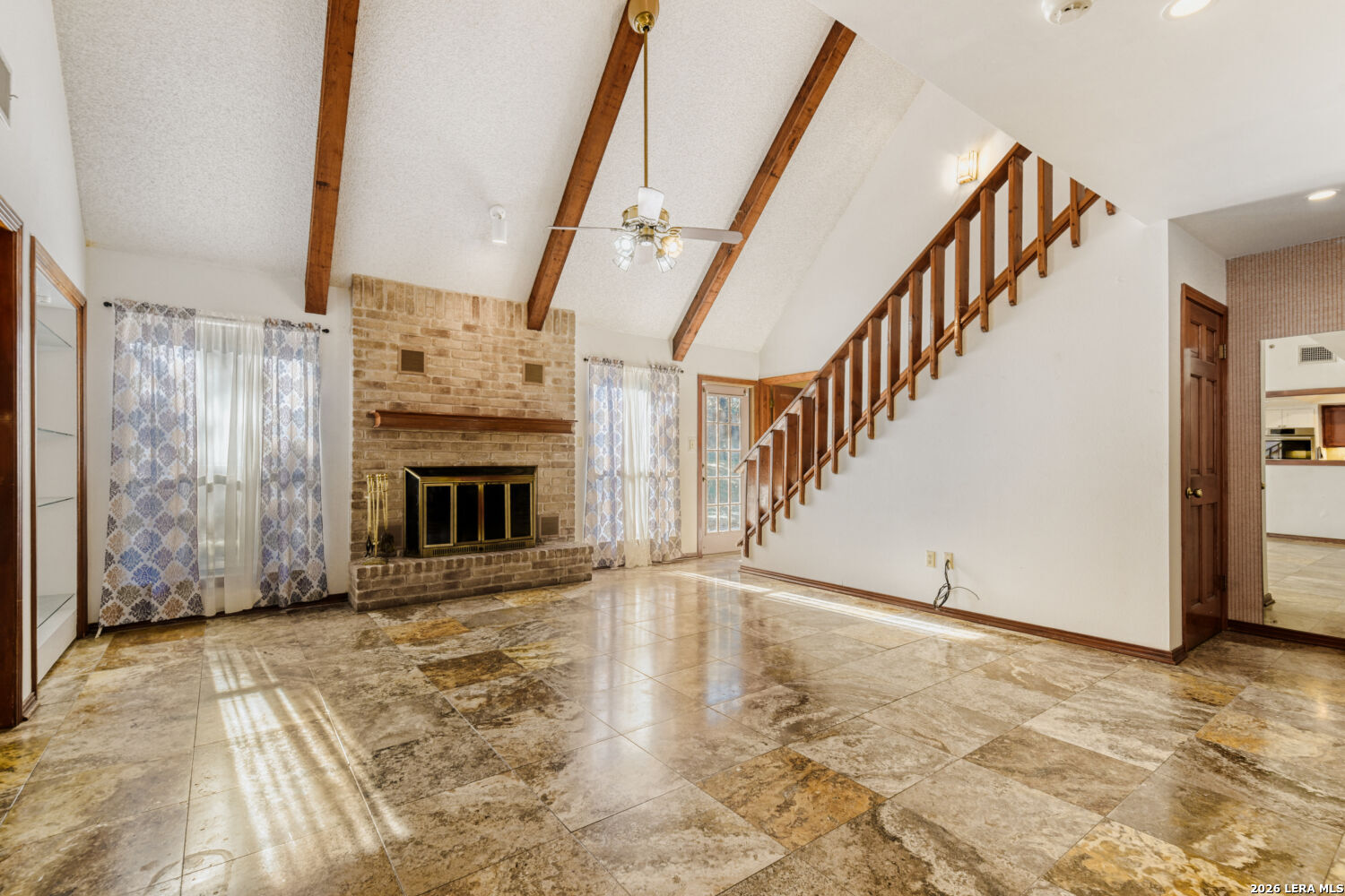 29342 Seabiscuit Drive Fair Oaks Ranch, TX 78015 - Photo 25 of 45 a view of an empty room with wooden floor and a fireplace