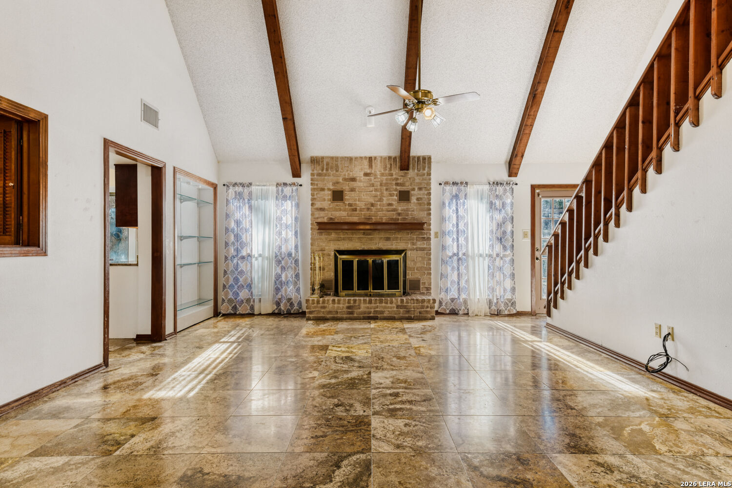 29342 Seabiscuit Drive Fair Oaks Ranch, TX 78015 - Photo 29 of 45 a view of an empty room with wooden floor and a fireplace