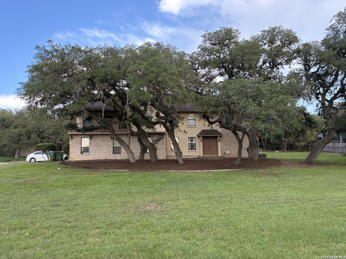 29342 Seabiscuit Drive Fair Oaks Ranch, TX 78015 - Photo 3 of 45 a front view of a house with a yard and trees