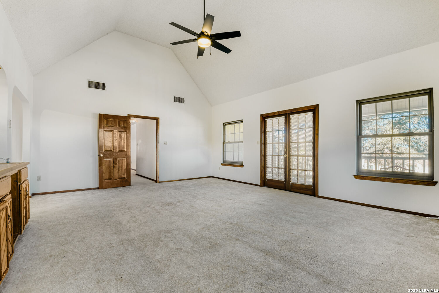 29342 Seabiscuit Drive Fair Oaks Ranch, TX 78015 - Photo 38 of 45 a view of an empty room with chandelier fan and windows