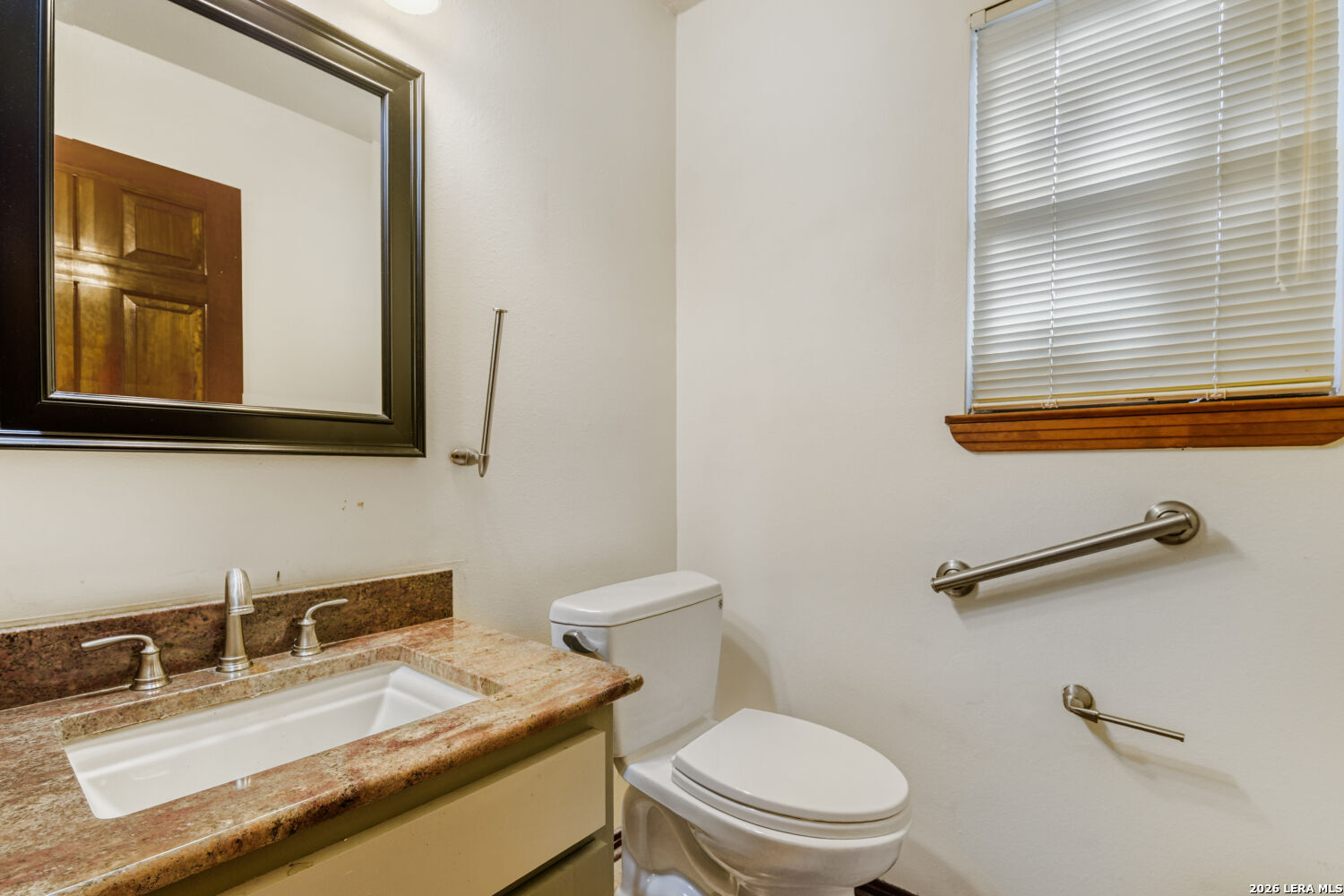 29342 Seabiscuit Drive Fair Oaks Ranch, TX 78015 - Photo 41 of 45 a bathroom with a granite countertop toilet sink and mirror