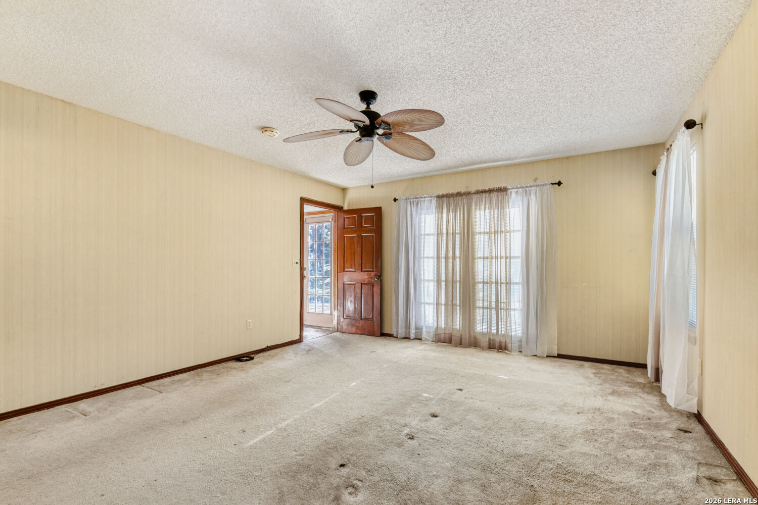 29342 Seabiscuit Drive Fair Oaks Ranch, TX 78015 - Photo 43 of 45 a view of a livingroom with a ceiling fan and window