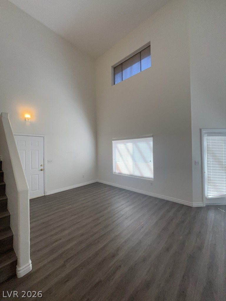 4915 East Russell Road, Unit 154 Las Vegas, NV 89120 - Photo 6 of 20 Towering ceilings and wood-look flooring define this open living space.