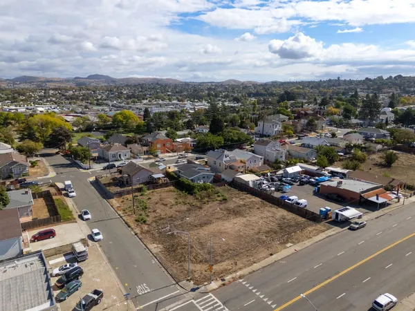 an aerial view of residential houses with city view