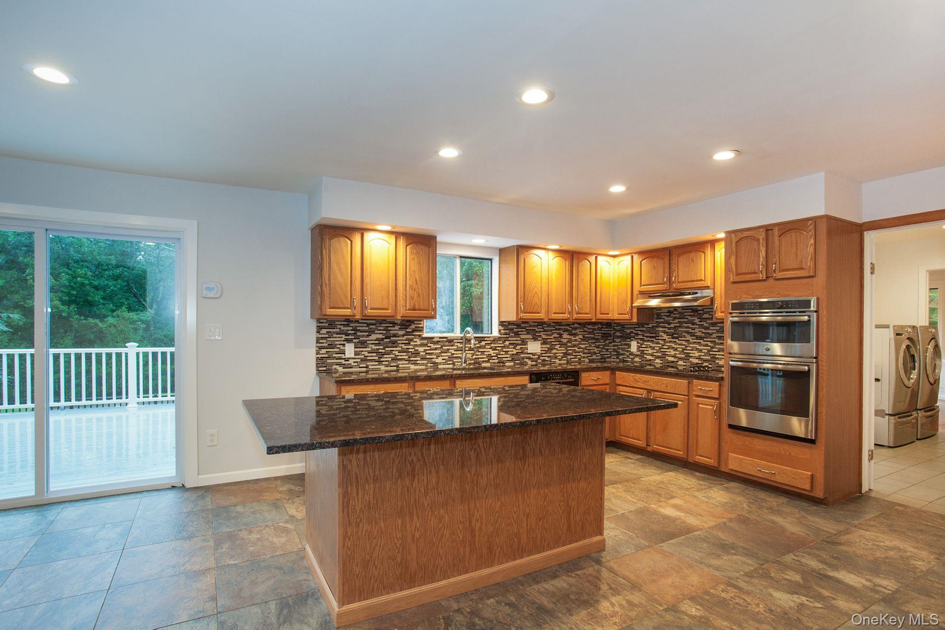 12 North Ridge Road Setauket, NY 11733 - Photo 12 of 34 a kitchen with stainless steel appliances granite countertop a stove and a sink