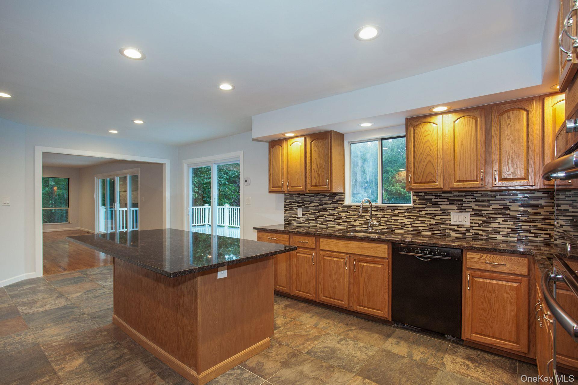 12 North Ridge Road Setauket, NY 11733 - Photo 13 of 34 a kitchen with granite countertop sink stove and cabinets