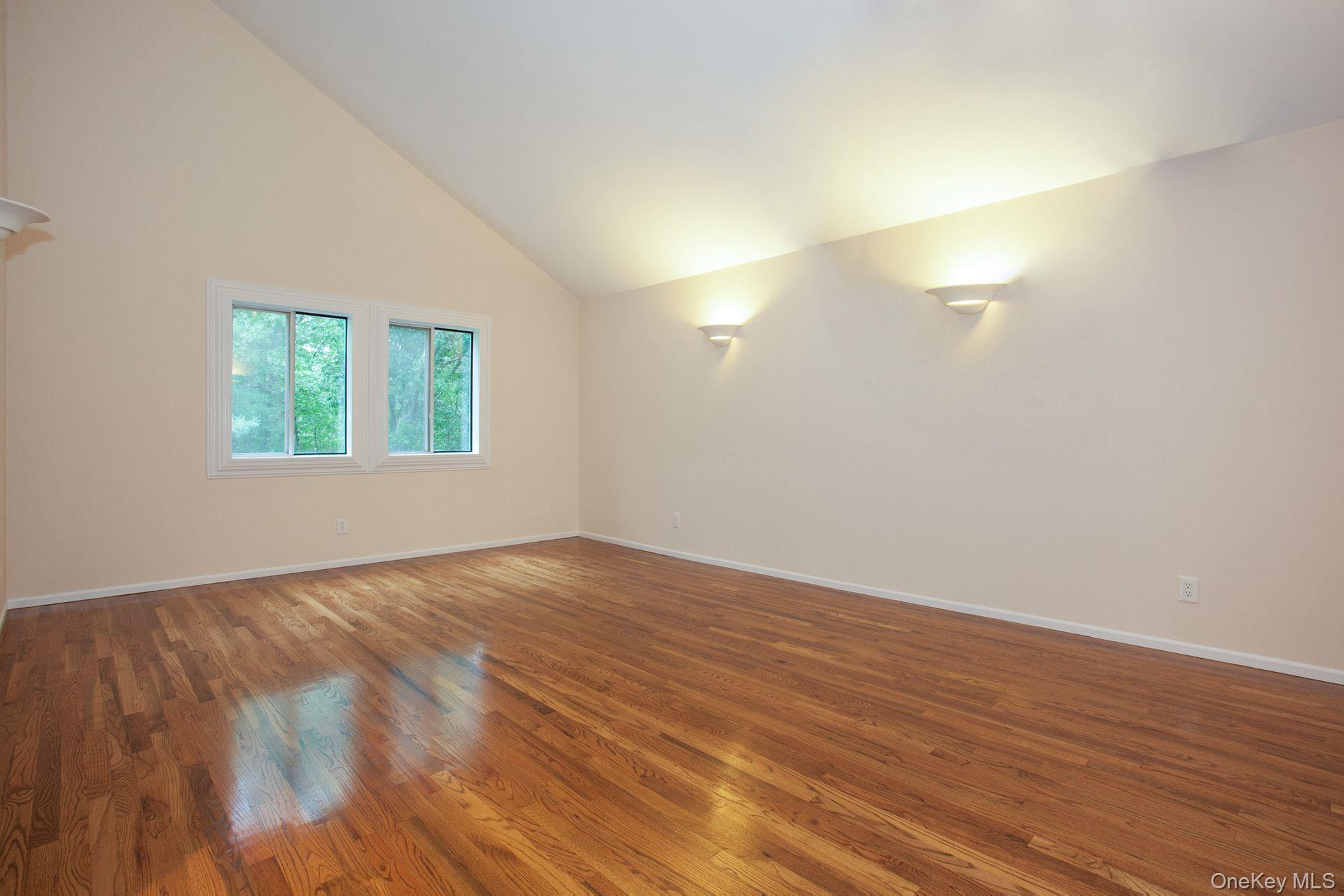 12 North Ridge Road Setauket, NY 11733 - Photo 16 of 34 a view of an empty room with wooden floor and a window