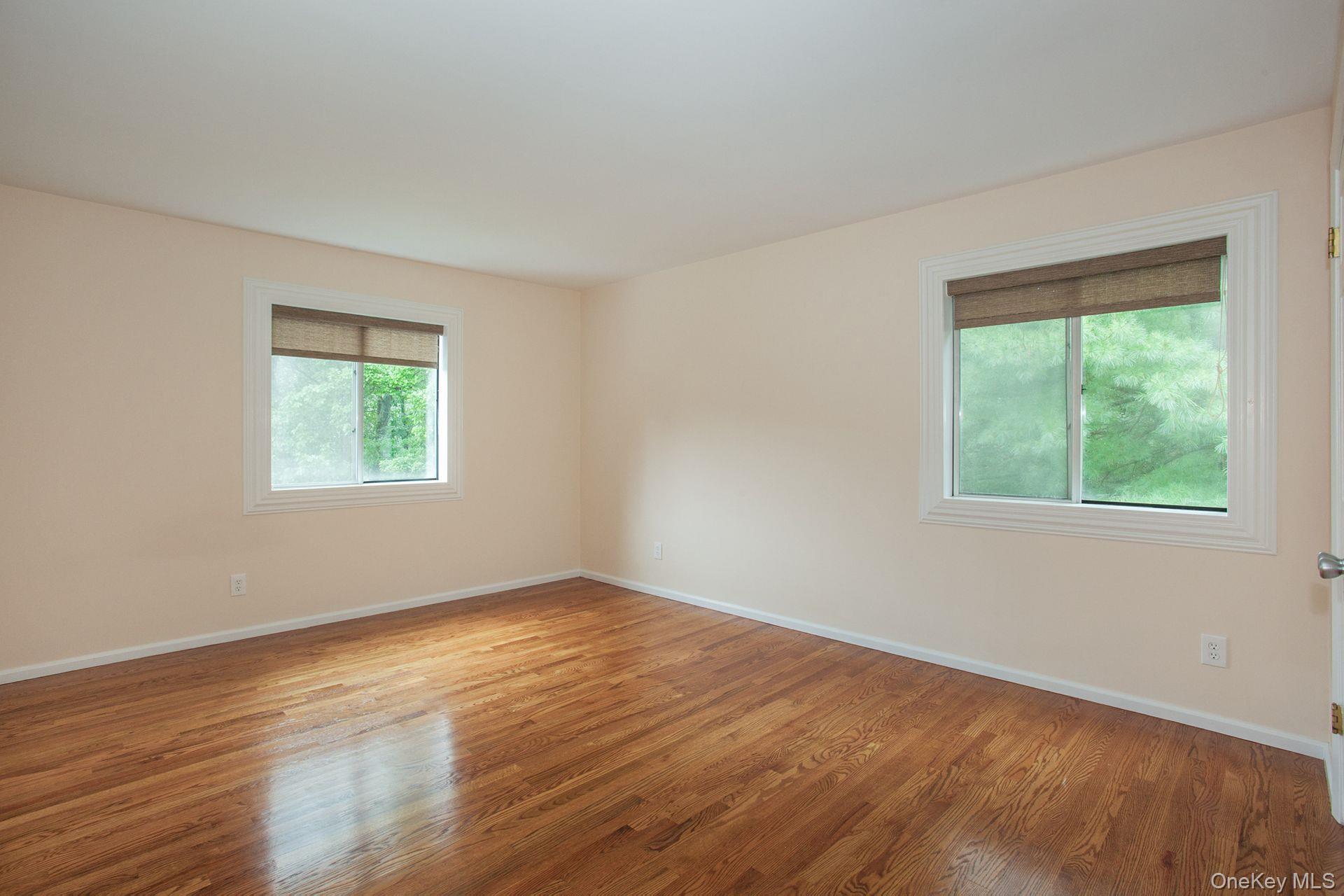 12 North Ridge Road Setauket, NY 11733 - Photo 17 of 34 a view of an empty room with wooden floor and a window