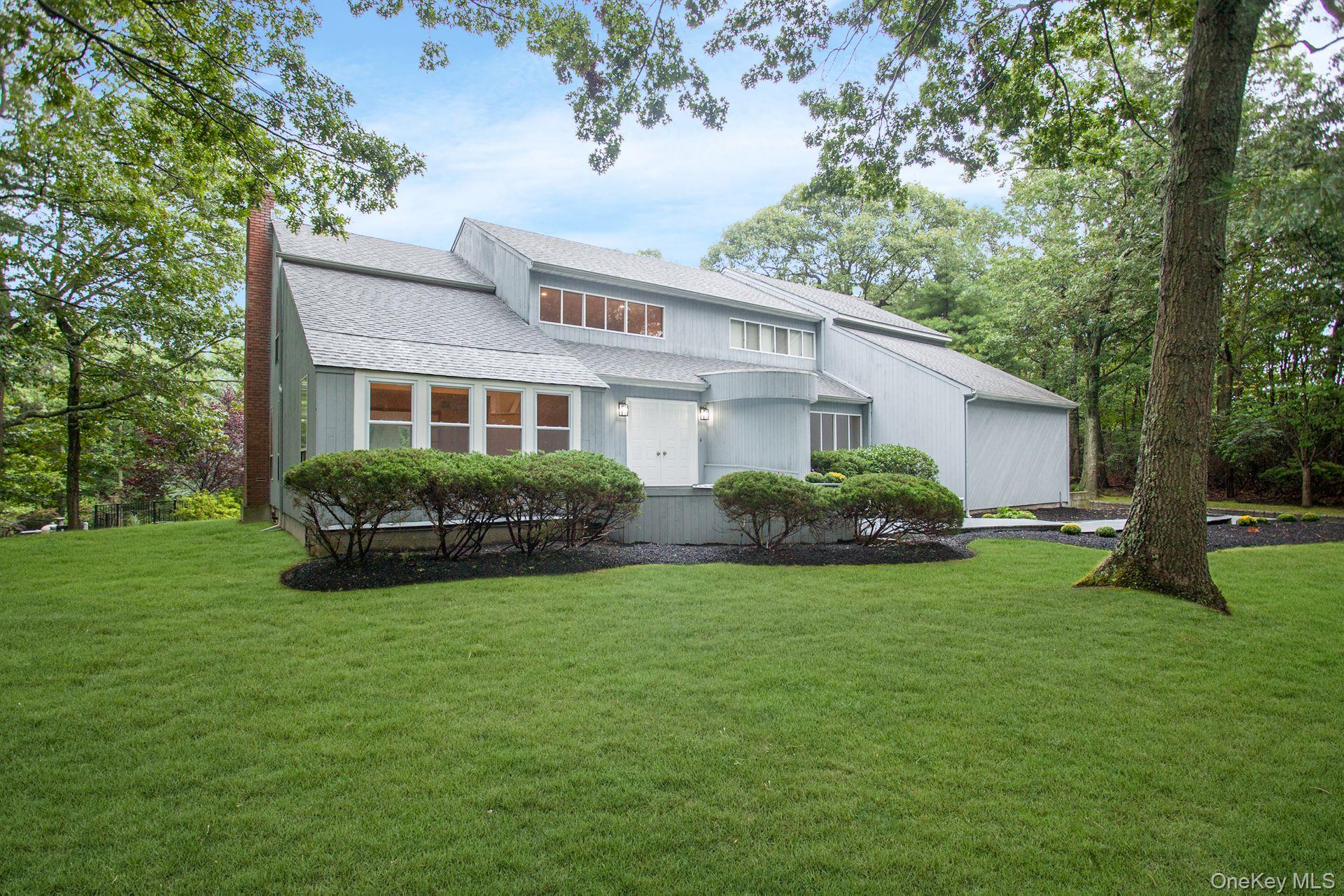 12 North Ridge Road Setauket, NY 11733 - Photo 3 of 34 a house view with a garden space