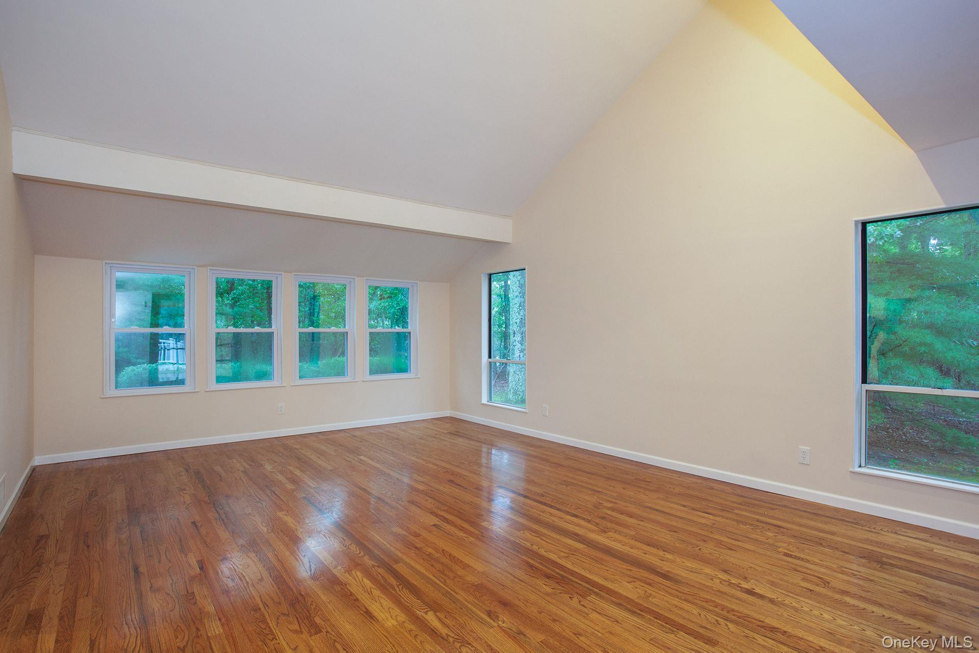 12 North Ridge Road Setauket, NY 11733 - Photo 5 of 34 a view of an empty room with wooden floor and a window