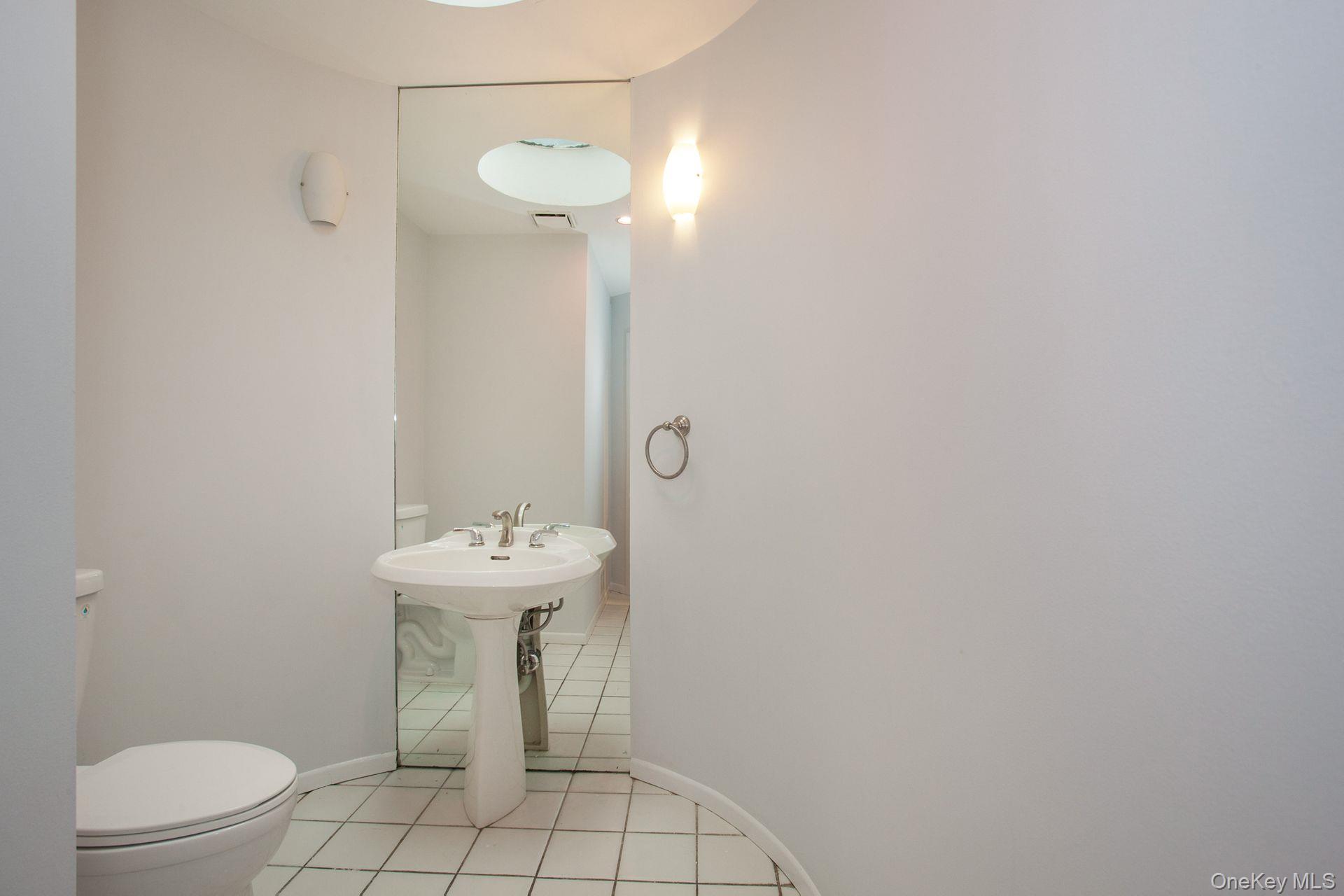 12 North Ridge Road Setauket, NY 11733 - Photo 7 of 34 a bathroom with a sink a toilet and mirror