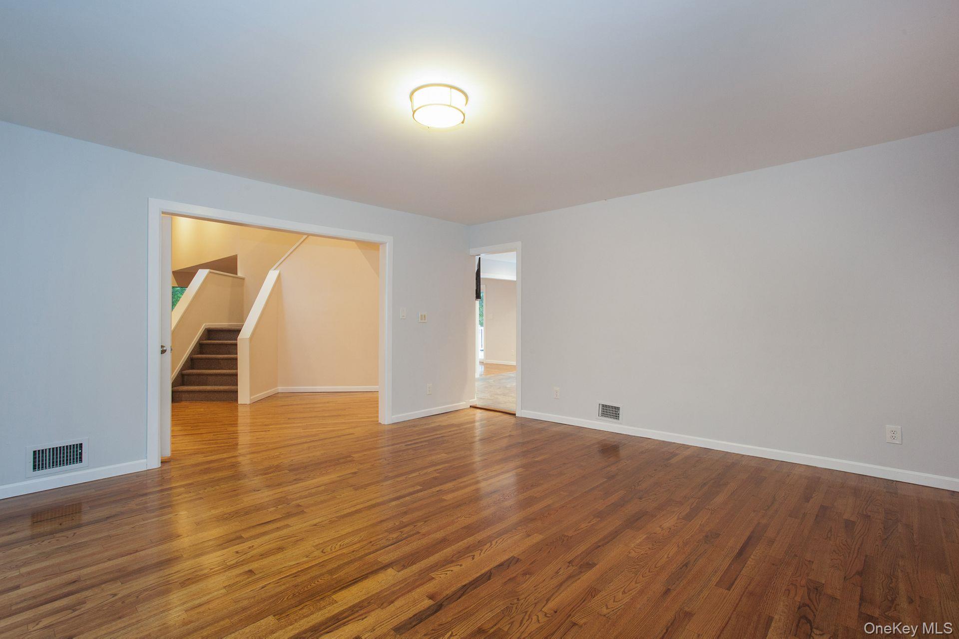 12 North Ridge Road Setauket, NY 11733 - Photo 9 of 34 a view of an empty room with wooden floor and a window