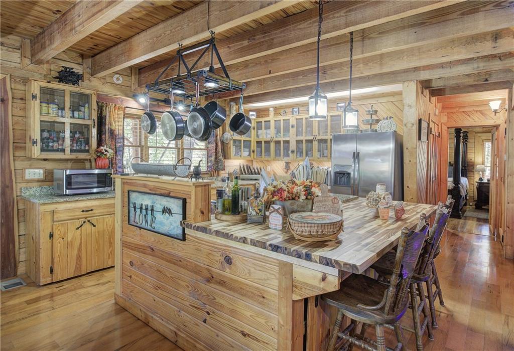 647 Knight Bottom Road Fairmount, GA 30139 - Photo 16 of 62 a view of a dining room with furniture a chandelier and kitchen view