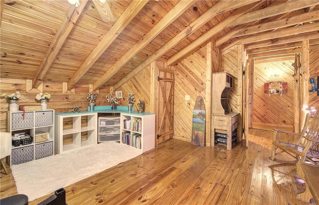 647 Knight Bottom Road Fairmount, GA 30139 - Photo 23 of 62 a room with wooden floors and furniture