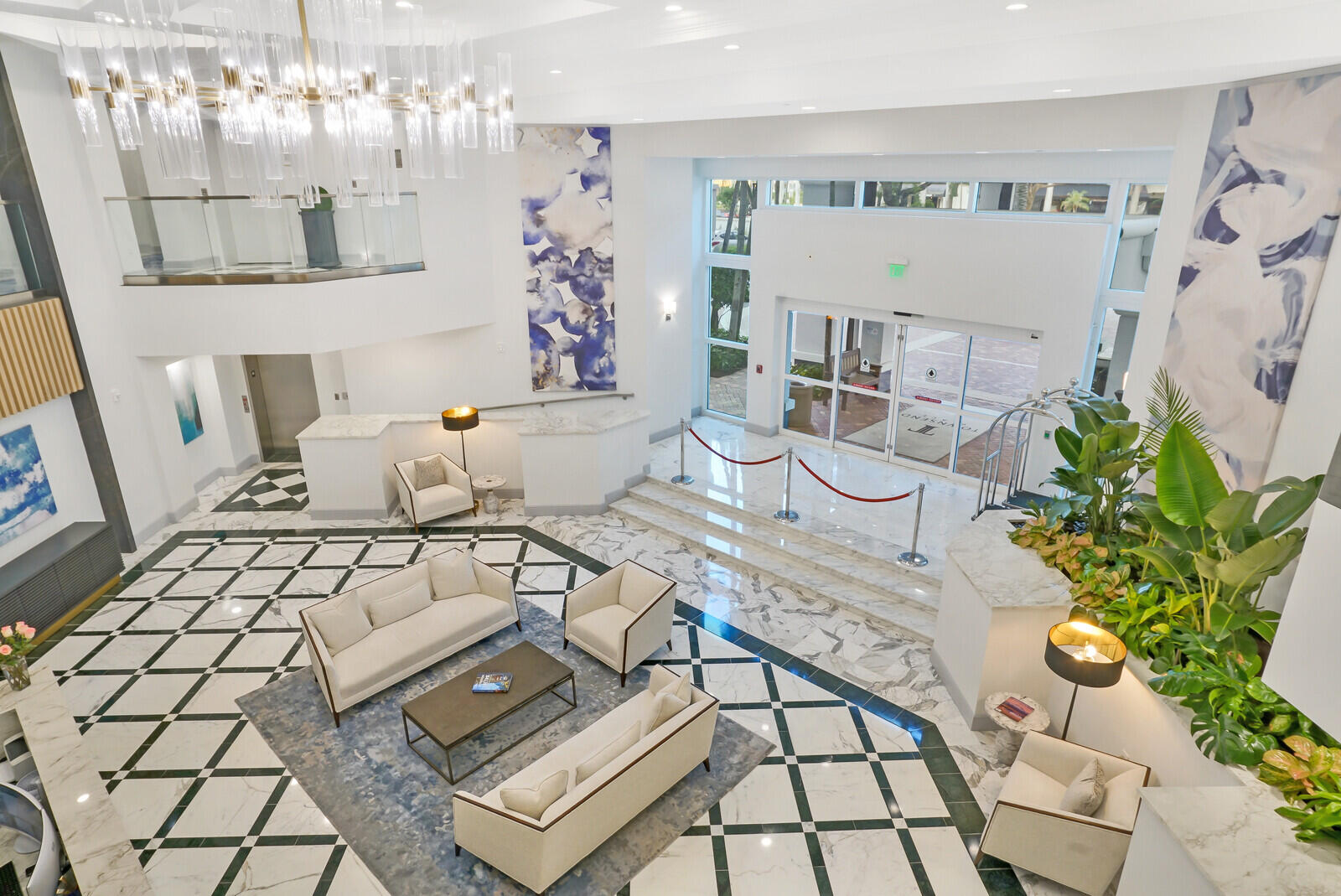 500 Southeast Mizner Boulevard, Unit A902 Boca Raton, FL 33432 - Photo 14 of 23 a living room with furniture and a chandelier