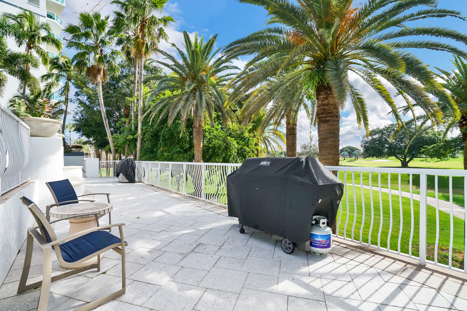 500 Southeast Mizner Boulevard, Unit A902 Boca Raton, FL 33432 - Photo 22 of 23 a view of a chair and tables in the patio