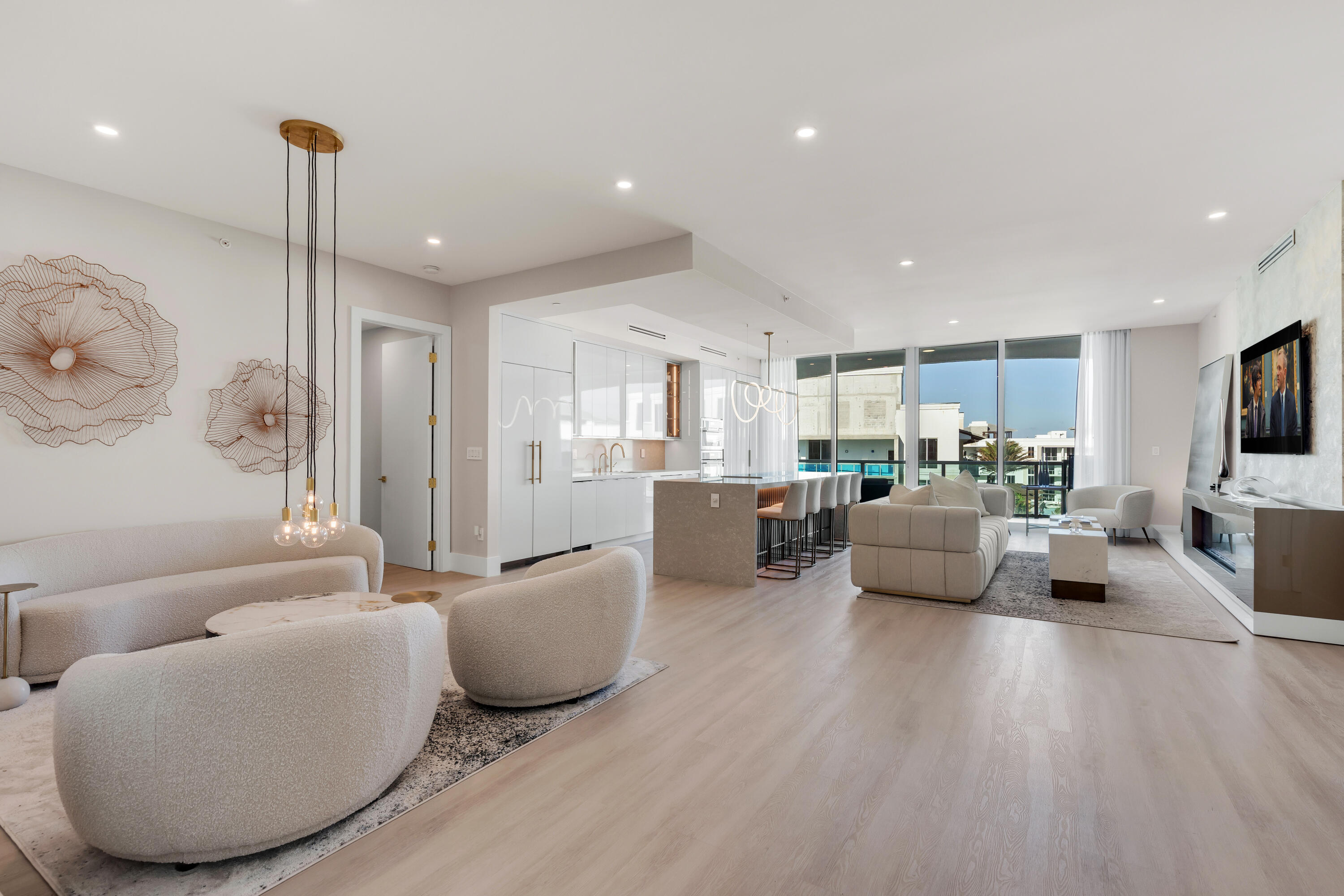 500 Southeast Mizner Boulevard, Unit A902 Boca Raton, FL 33432 - Photo 3 of 23 a living room with furniture kitchen view and a wooden floor