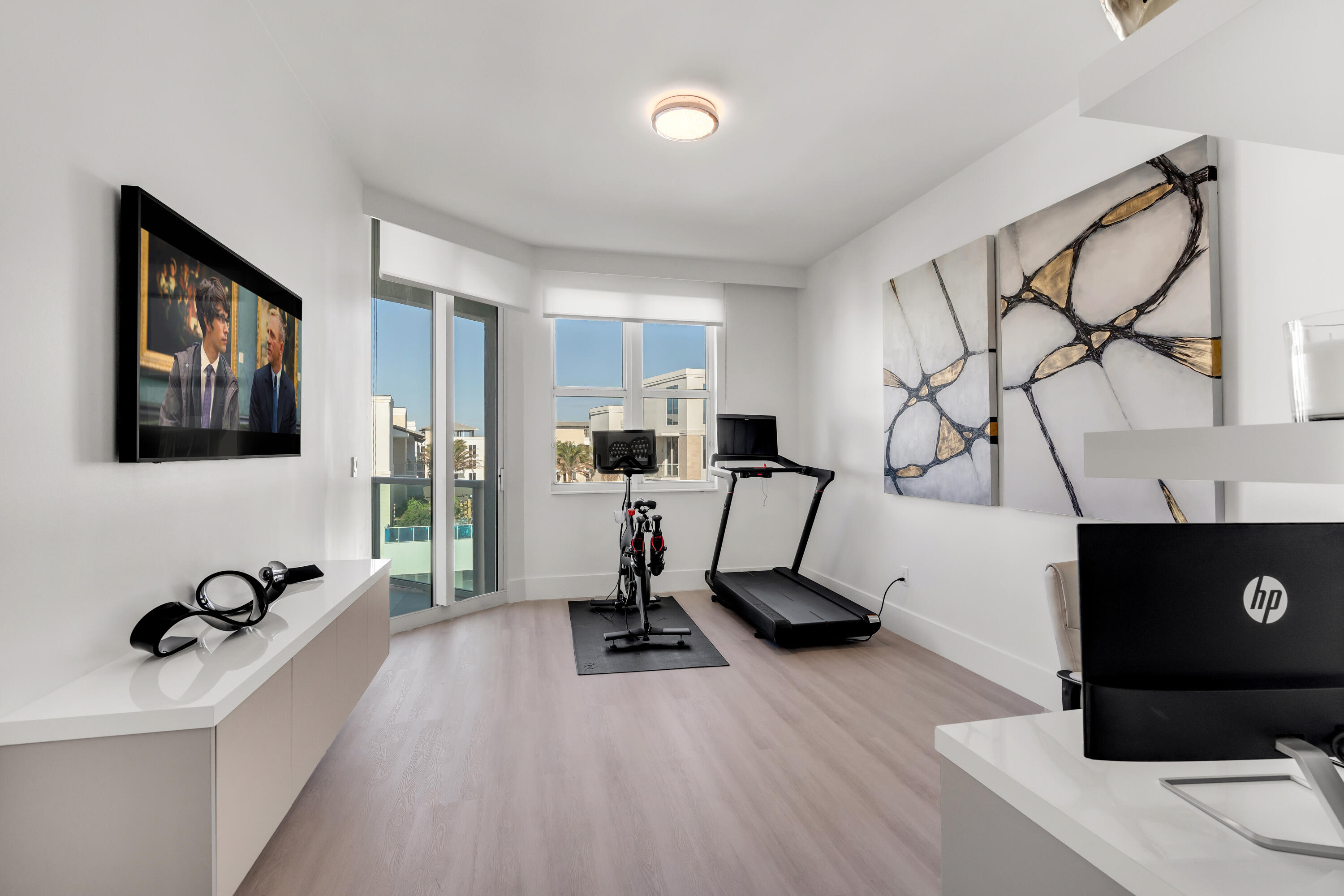 500 Southeast Mizner Boulevard, Unit A902 Boca Raton, FL 33432 - Photo 9 of 23 a view of a workspace with furniture and a flat screen tv