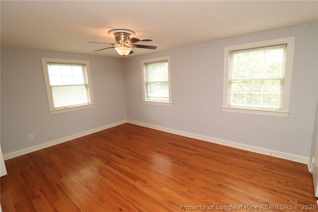 1000 Nichols Drive Raleigh, NC 27605 - Photo 14 of 22 a view of an empty room with wooden floor and a window