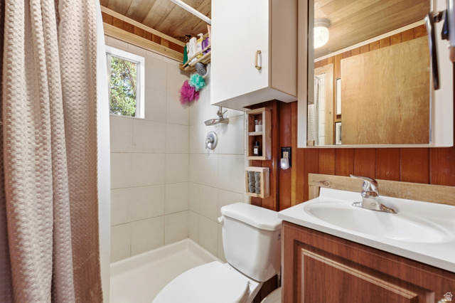 6631 Pine Springs Road Kamas, UT 84036 - Photo 15 of 48 Full bath featuring wooden walls, vanity, a stall shower, and wooden ceiling
