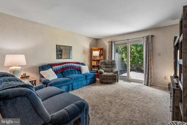 a bedroom with furniture and a large window