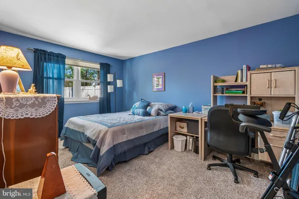 a bedroom with a bed chair and window