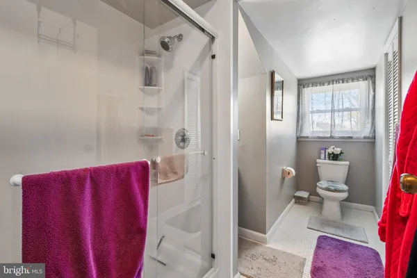 a bathroom with a toilet and shower