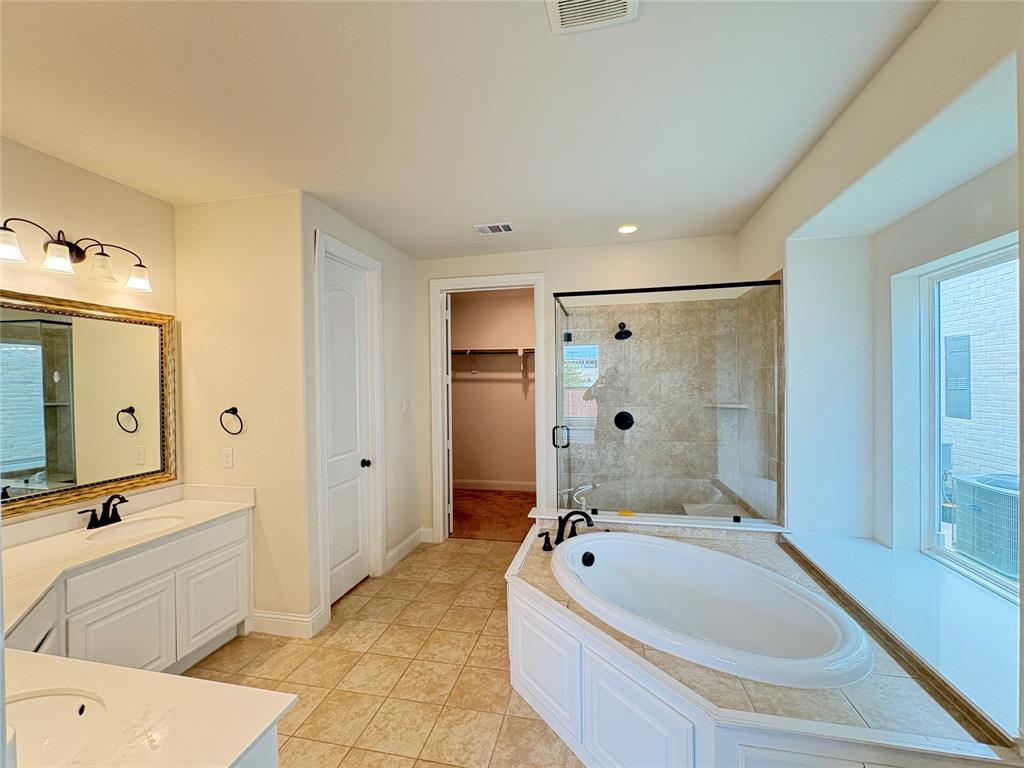 323 Butternut Way Irving, TX 75063 - Photo 17 of 32 a bathroom with a tub a sink and mirror