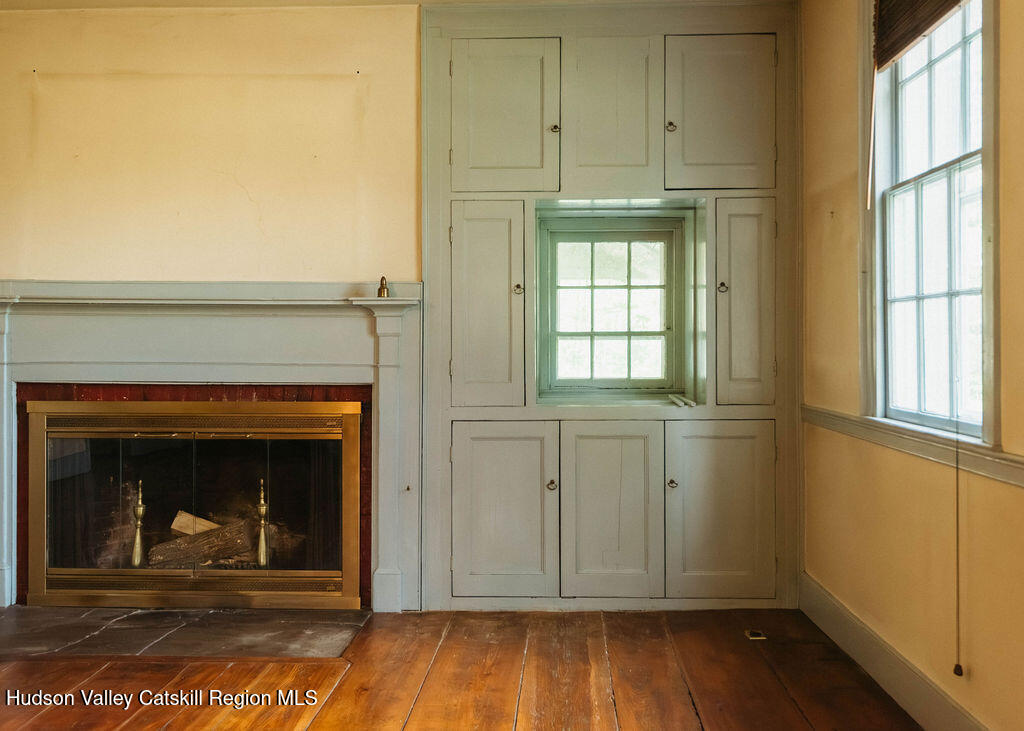 652 Albany Post Road New Paltz, NY 12561 - Photo 15 of 36 a view of livingroom with hardwood floor and a fireplace