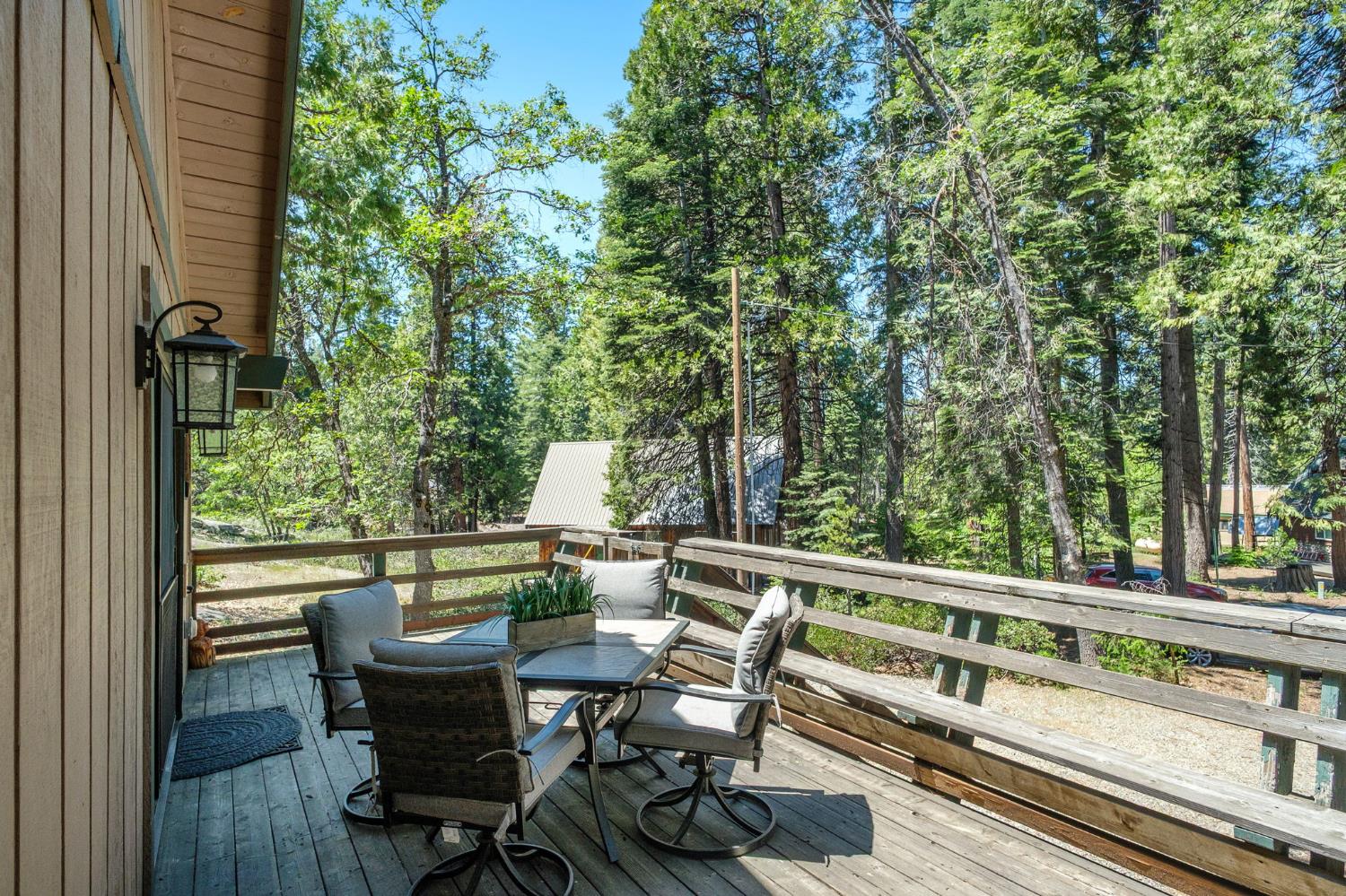 42488 Rock Ledge Road Shaver Lake, CA 93664 - Photo 8 of 26 a view of a chairs and table in the balcony