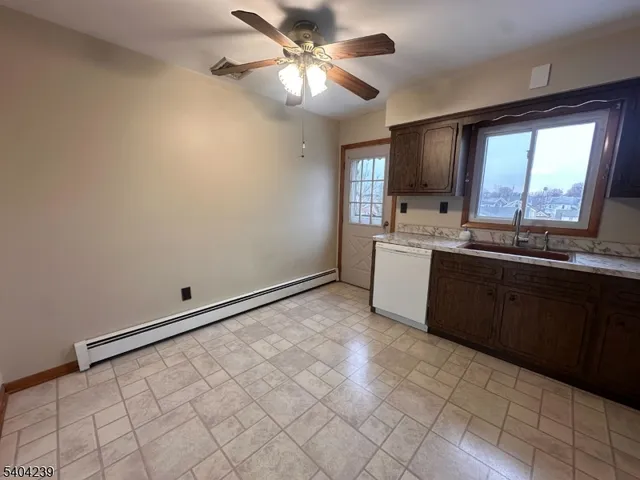 a kitchen with a sink cabinets and window