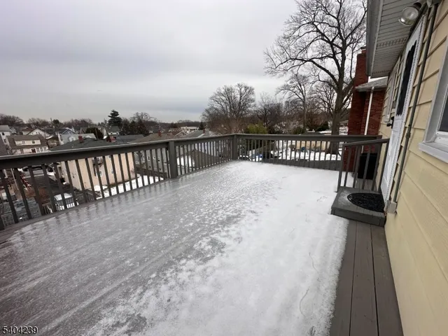 a view of balcony with wooden floor and fence