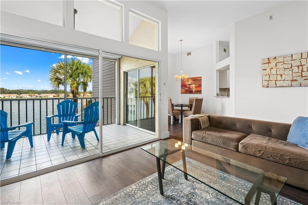 2711 Citrus Lake Drive, Unit F302 Naples, FL 34109 - Photo 3 of 20 a living room with furniture and a large window
