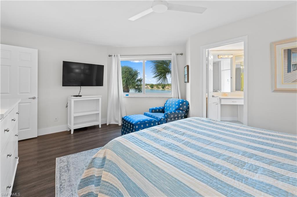 2711 Citrus Lake Drive, Unit F302 Naples, FL 34109 - Photo 6 of 20 a bedroom with a bed and a flat screen tv