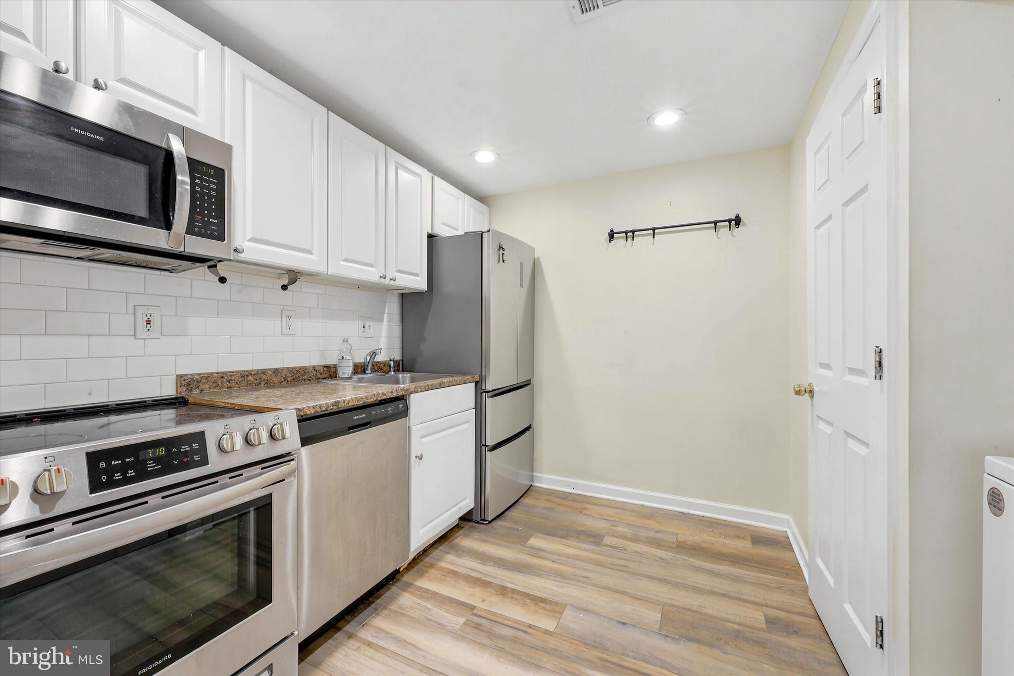 33 South 19th Street Philadelphia, PA 19103 - Photo 10 of 15 a kitchen with stainless steel appliances granite countertop a refrigerator stove and microwave
