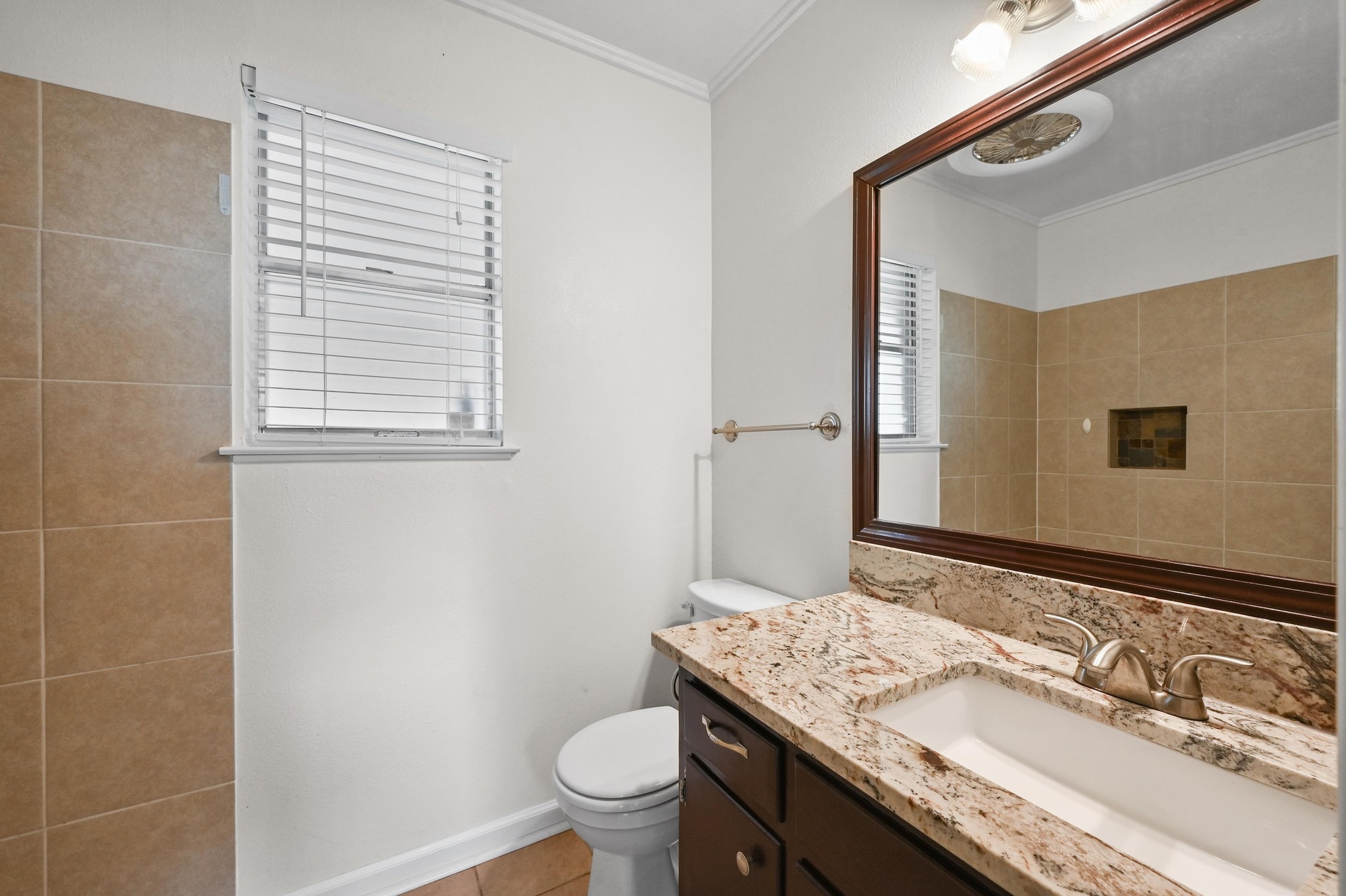 2018 Chaparral Park Road Manchaca, TX 78652 - Photo 19 of 26 a bathroom with a granite countertop sink a toilet and a mirror