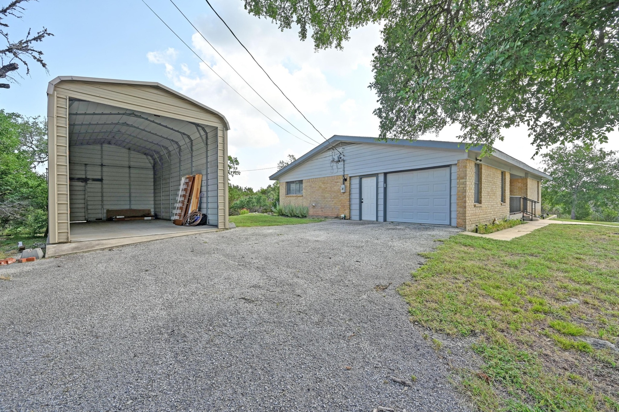 2018 Chaparral Park Road Manchaca, TX 78652 - Photo 25 of 26 a view of a house with a small yard and large tree