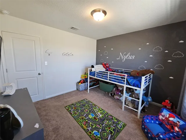 a reading room with furniture and rug