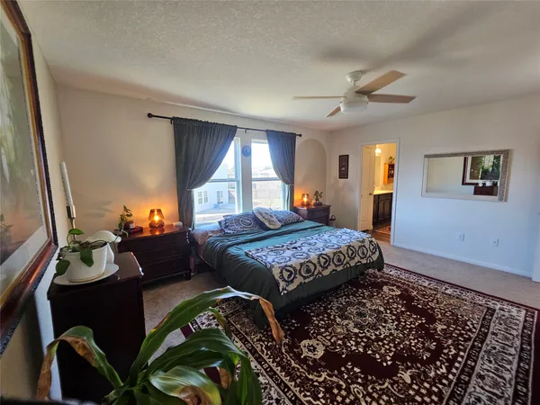 a bedroom with a bed and a dresser with wooden floor